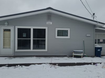 muscatine siding replacement - street view of house with new gray siding, after