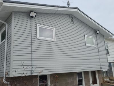 muscatine siding replacement - backyard view of house with new gray siding, after