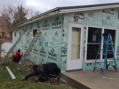 muscatine siding replacement - front corner of house with new siding layers, during