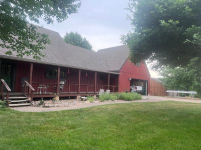 milan siding replacement - street view of red ranch-style house, after