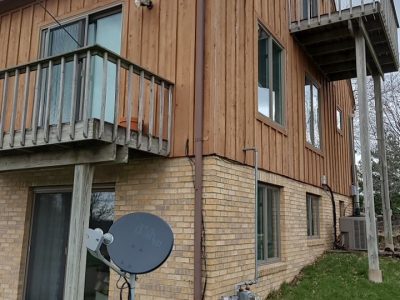 milan siding replacement - outside corner of two-story house, before