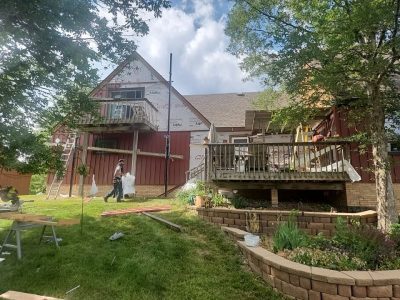 milan siding replacement - contractors working on back of house, during