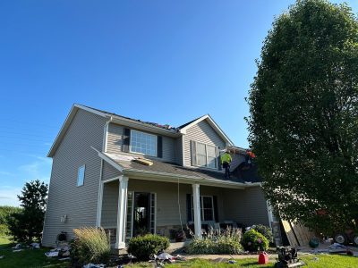 davenport roofing installation - street view of house with contractors, during