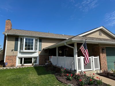 davenport roofing replacement - street view of house with damaged roof, before