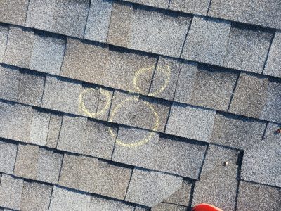 davenport roofing installation - circled broken roof tiles, before