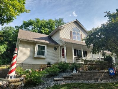 moline roofing replacement - street view of two-story house with new roof, after