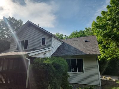 moline roofing replacement - back view of two-story house with new roof, after