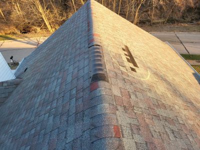 moline roofing replacement - peak of old roof with missing tiles, before