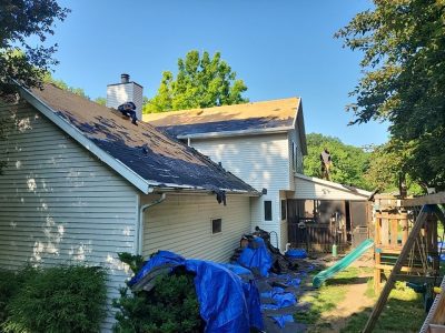 moline roofing replacement - contractors removing old roof pieces, during - 2