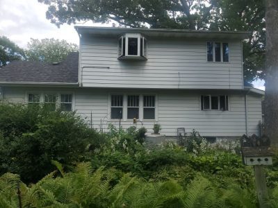 rock island roofing replacement - side view of white ranch-style house, before