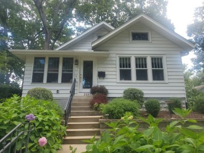 rock island roofing replacement - street view of white ranch-style house, before