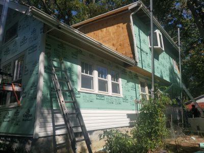 rock island roofing replacement - side of house new siding being installed, during