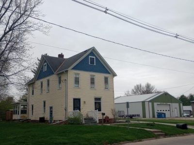 cambridge roofing replacement - street view of yellow two-story house, before