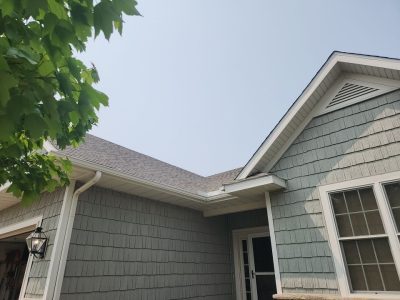 davenport roofing replacement - close-up front yard view of tan house with new roof, after