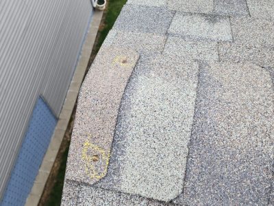 davenport roofing replacement - corner with warped roof shingles, before