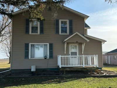 orion window replacement - exterior tan two-story house, before