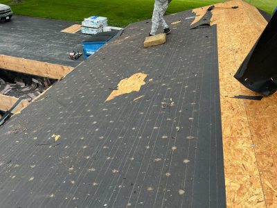 silvis roofing installation - old roof layers being removed, during