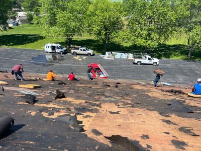 silvis roofing installation - workers removing old roof, during