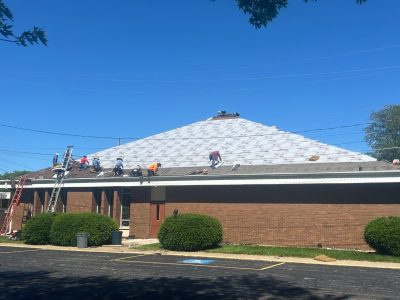 silvis roofing installation - street view of workers on roof, during