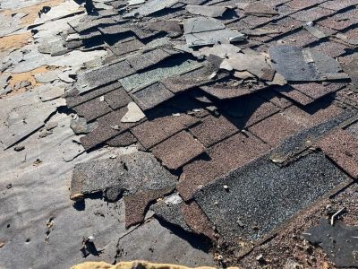 silvis roofing installation - old roof shingles being torn out, during