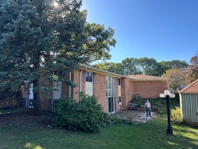 east moline roofing installation - street view of two-story brick tan house, before