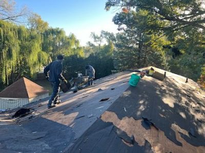 east moline roofing installation - workers installing new roof layers, during