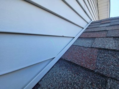 davenport siding installation - corner of house broken tan siding, before - 2