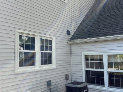 rock island roofing installation - side corner of house with new gray siding and black roof, after