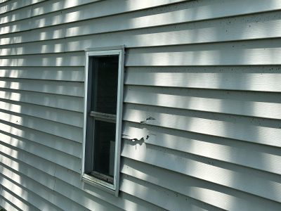 rock island roofing installation - broken siding on house, before