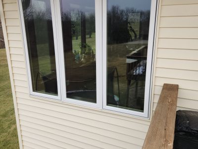 swisher window installation - outside view of three long patio/kitchen windows, after