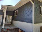 colona siding replacement - front entryway of house with new blue siding, after