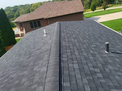 orion roofing replacement - new gray peak of house roof, after