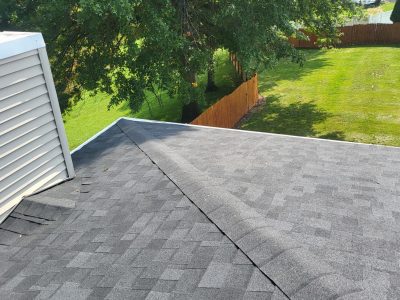 orion roofing replacement - new gray peak of roof, after