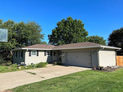 orion roofing replacement - garage side view of large two-story house, before