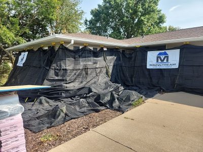 orion roofing replacement - Mainstream protective tarp on house, during