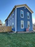 aledo siding replacement - street view of tall two-story house with new blue siding, after
