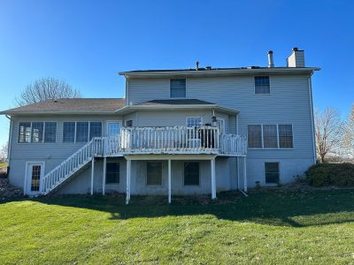 long grove window replacement - backyard view of gray two-story house, before