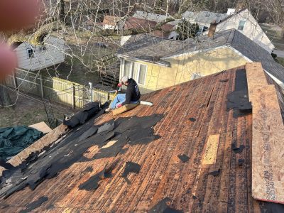 moline roofing installation - contractors removing old roof boards, during