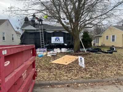 moline roofing installation - Mainstream logo, dumpster, and construction materials, during