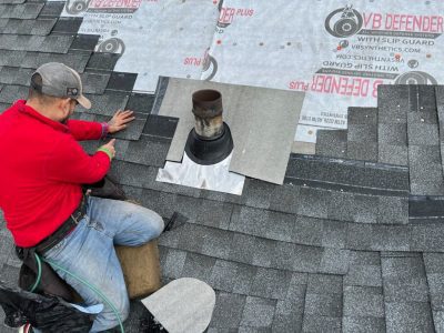 moline roofing installation - worker installing roof around furnace top, during