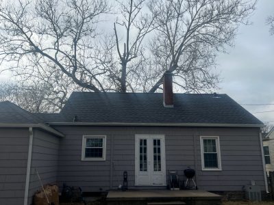 rock island roofing installation - street view of gray house with new black roof, after