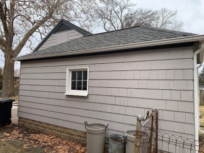 rock island roofing installation - garage view of small gray house, before