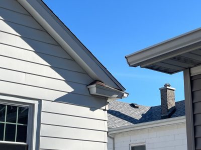 moline roofing replacement - corner view of white house with new brown roof, after