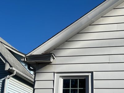 moline roofing replacement - corner view of white house with new brown roof, after - 2