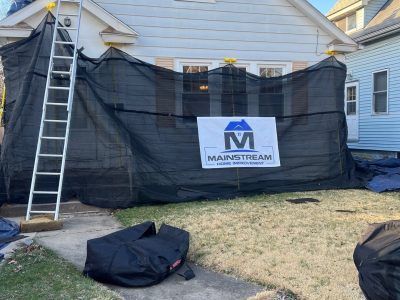 moline roofing replacement - company logo and protection tarp, during