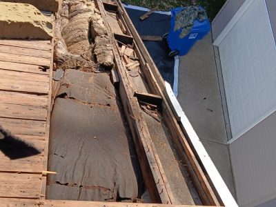 moline roofing replacement - old broken boards removed from roof, during