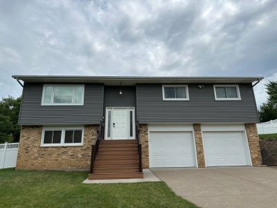 taylor ridge siding installation - front view of two story-house with new dark gray siding, after