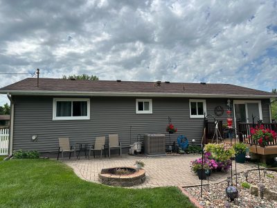 taylor ridge siding installation - backyard view of two story-house with new dark gray siding, after