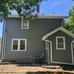 rock island siding replacement - backyard view of new gray siding on two-story house, after