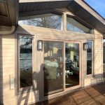 moline patio door replacement - outside left view of new glass patio doors with two triangle windows above, after